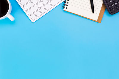 High angle view of book on table against blue background