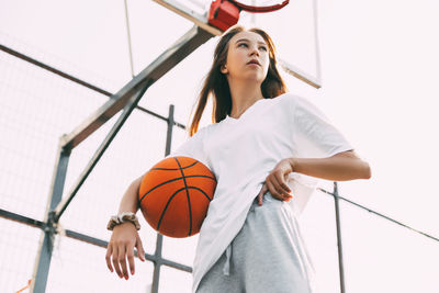 Portrait of young female basketball player. beautiful teen girl playing basketball. 