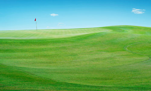 Golf course against sky