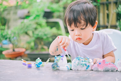 Cute boy playing with toys