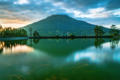 Scenic view of lake and mountains against sky
