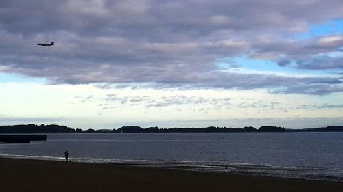 Scenic view of sea against cloudy sky