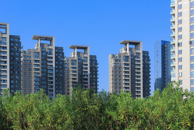 View of cityscape against clear blue sky