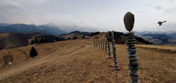 Scenic view of land and mountains against sky