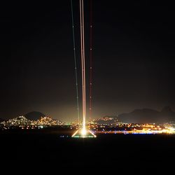 Illuminated mountain against sky at night