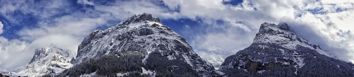 Low angle view of mountain against cloudy sky