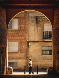 Full length of woman standing against building