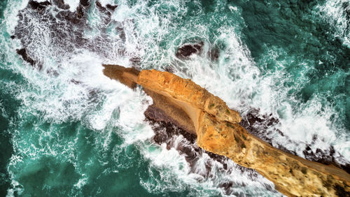 Aerial view of rock formation on sea shore