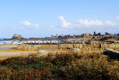 Panoramic shot of buildings on field against sky