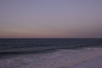 Scenic view of sea against clear sky at sunset