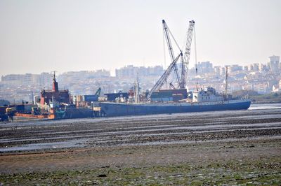 Ship moored at harbor against clear sky