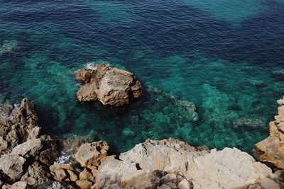 High angle view of rocks by sea