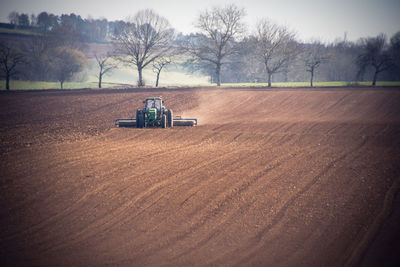 Scenic view of agricultural field with tractor