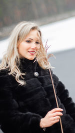 Portrait of a smiling young woman in winter