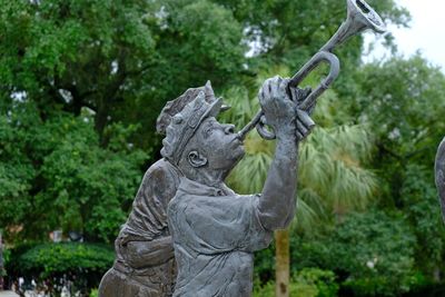 Close-up of statue against trees in park