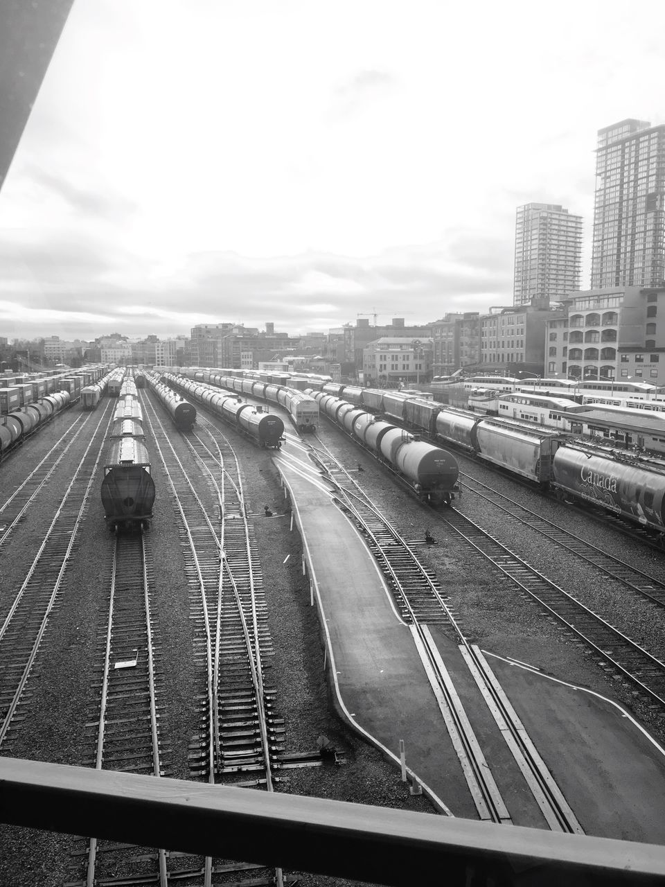 transportation, rail transportation, train - vehicle, railroad track, mode of transport, no people, high angle view, public transportation, sky, outdoors, day, land vehicle, building exterior, city, architecture, nature