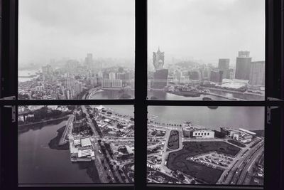 High angle view of buildings seen through glass window