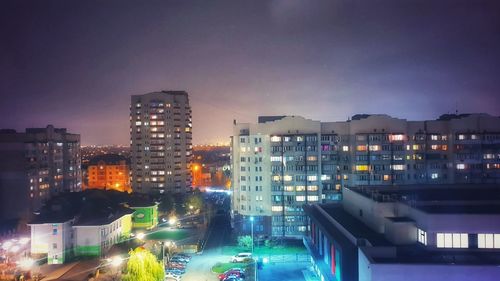 High angle view of illuminated buildings in city at night