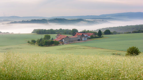 Houses on field against sky