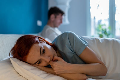 Young woman sleeping on bed at home