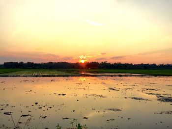 Scenic view of lake against sky during sunset