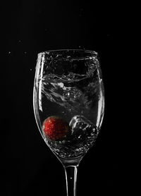 Close-up of wine glass against black background