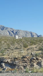 View of built structures against clear blue sky