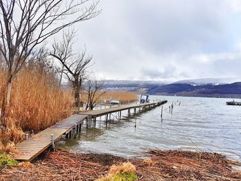 Scenic view of lake against sky during winter