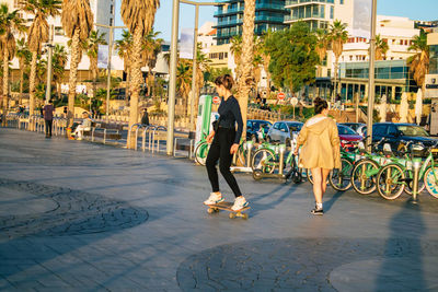 People walking on footpath in city