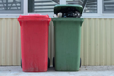 Close-up of garbage bin on footpath