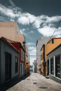 Street amidst buildings against sky