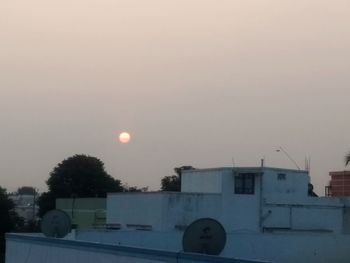 View of houses against sky during sunset