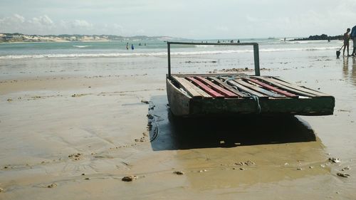Lifeguard hut on beach against sky
