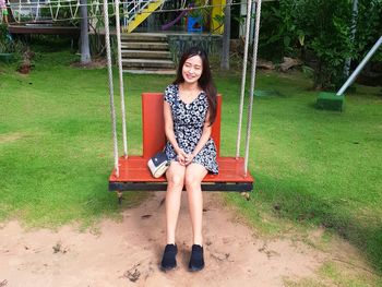 Portrait of smiling young woman sitting outdoors