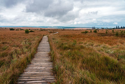 Footpath on field against sky