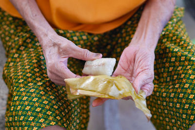 Midsection of woman holding food