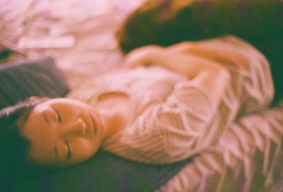 Close-up of baby sleeping on bed