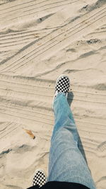 Low section of person on sand