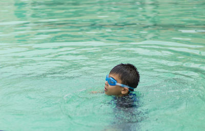 Boy swimming in pool