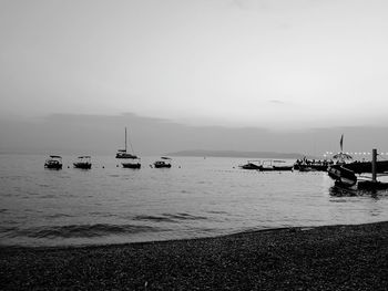 Sailboats in sea against clear sky