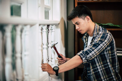 Side view of young man looking at home