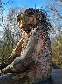 Low angle view of statue against bare trees