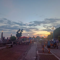 People on street in city at sunset