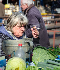 Man and woman sitting at market stall