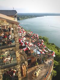 High angle view of people by sea against clear sky