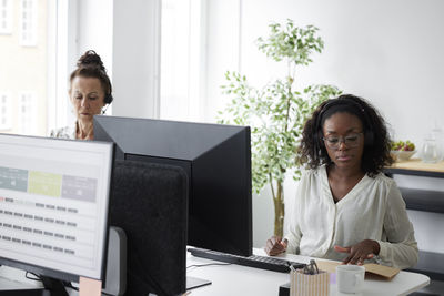 Women sitting at desk in office