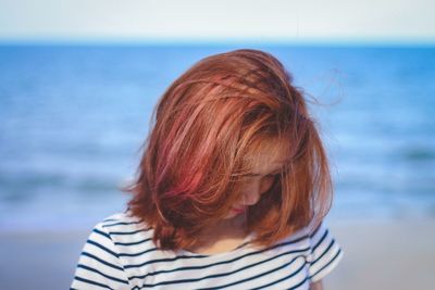 Close-up of young woman standing at beach