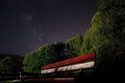 Low angle view of trees against sky at night