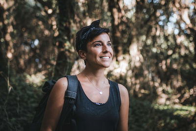 Portrait of a smiling young woman in forest