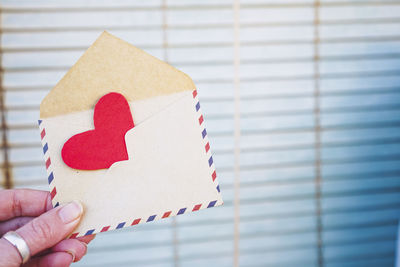 Cropped hand of woman holding envelope